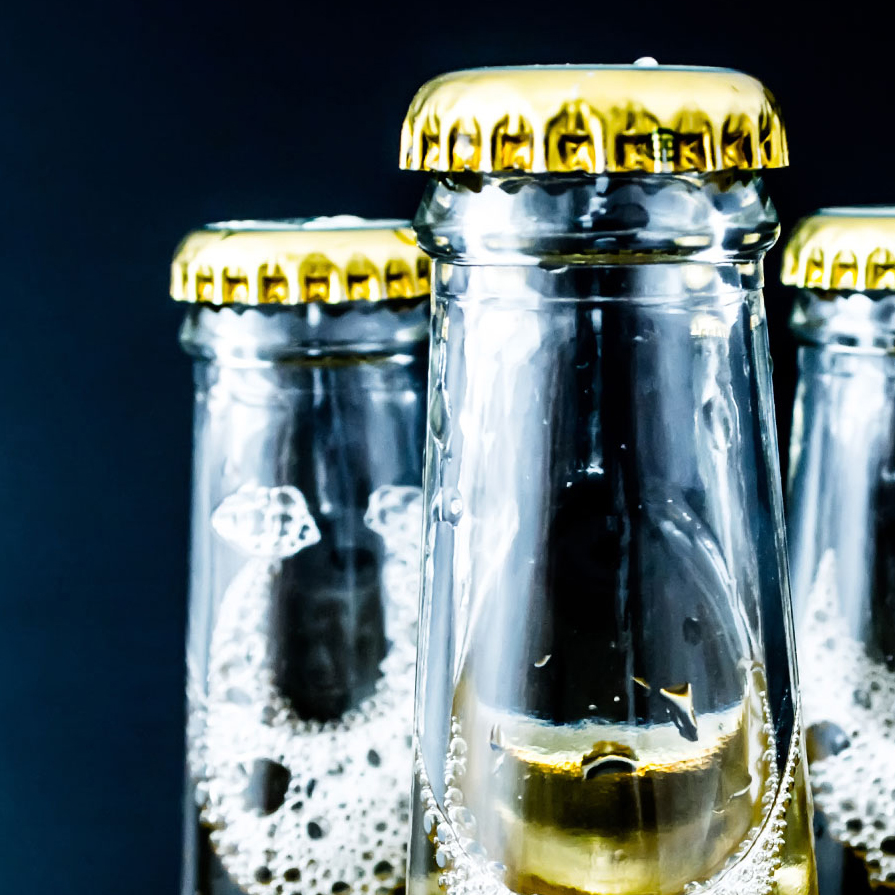 Three beer bottles with beer cap